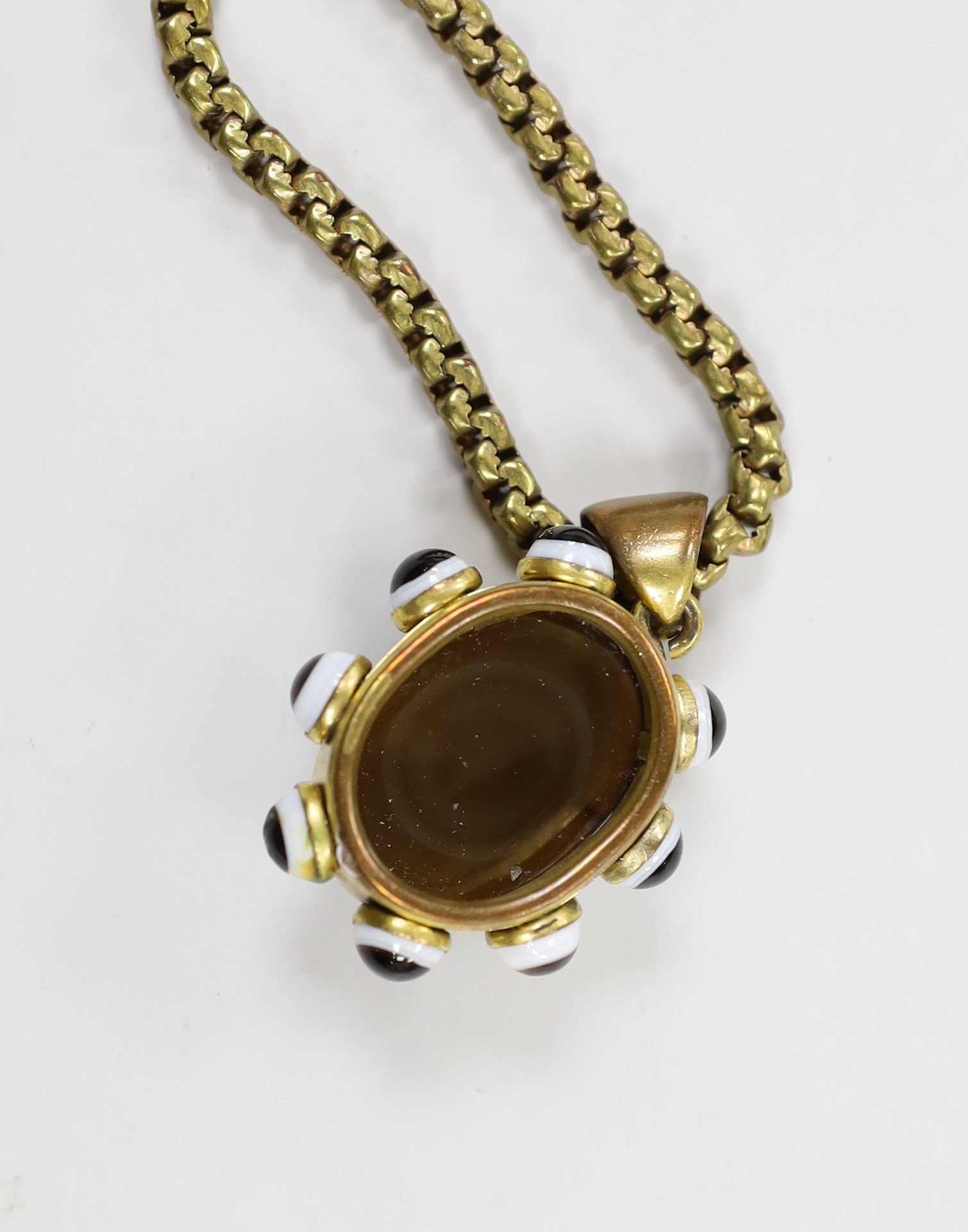 A Victorian pinchbeck and banded agate set pendant, 39mm, on a gilt metal chain.